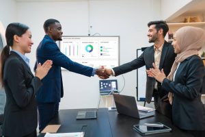 Business people shaking hands with a SARScore screen on rating score data