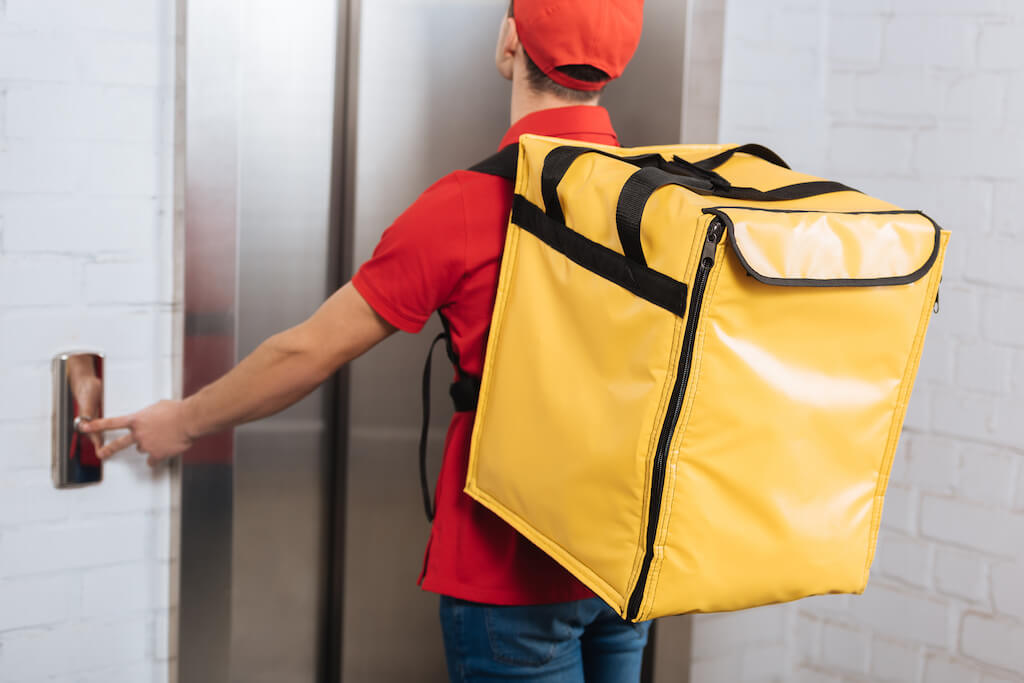 back view of of delivery man in red uniform with t 2023 11 27 05 09 14 utc 1